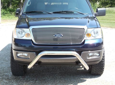 2005 Ford F-150 - Front view of a dark blue Ford F-150 pickup truck with a chrome bull bar and chrome grille.