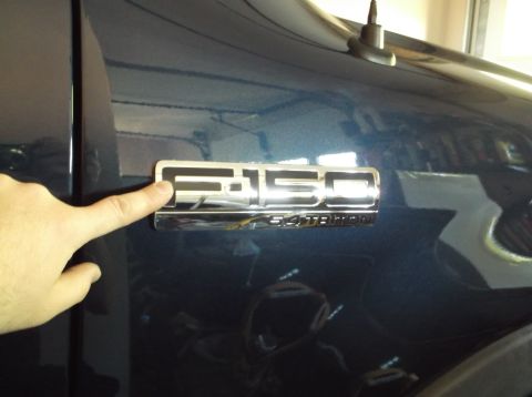 2005 Ford F-150 - F-150 badge clearly visible on the side of a dark blue truck.