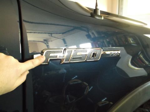 2005 Ford F-150 - Close-up of the F-150 FX4 emblem on the fender of a 2005 Ford truck.