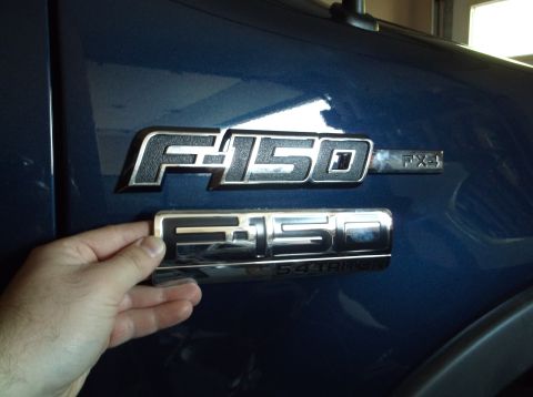 2005 Ford F-150 - Comparing F-150 emblems on a blue Ford truck. The FX4 badge is visible.