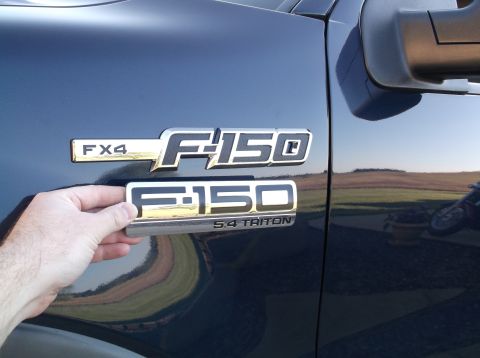 2005 Ford F-150 - Comparing F-150 5.4 Triton emblem with the factory FX4 F-150 emblem on a truck door.
