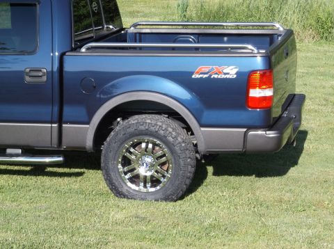 2005 Ford F-150 - Rear quarter view of a blue 2005 Ford F-150 FX4 pickup truck, aftermarket chrome wheels and FX4 off-road badging.