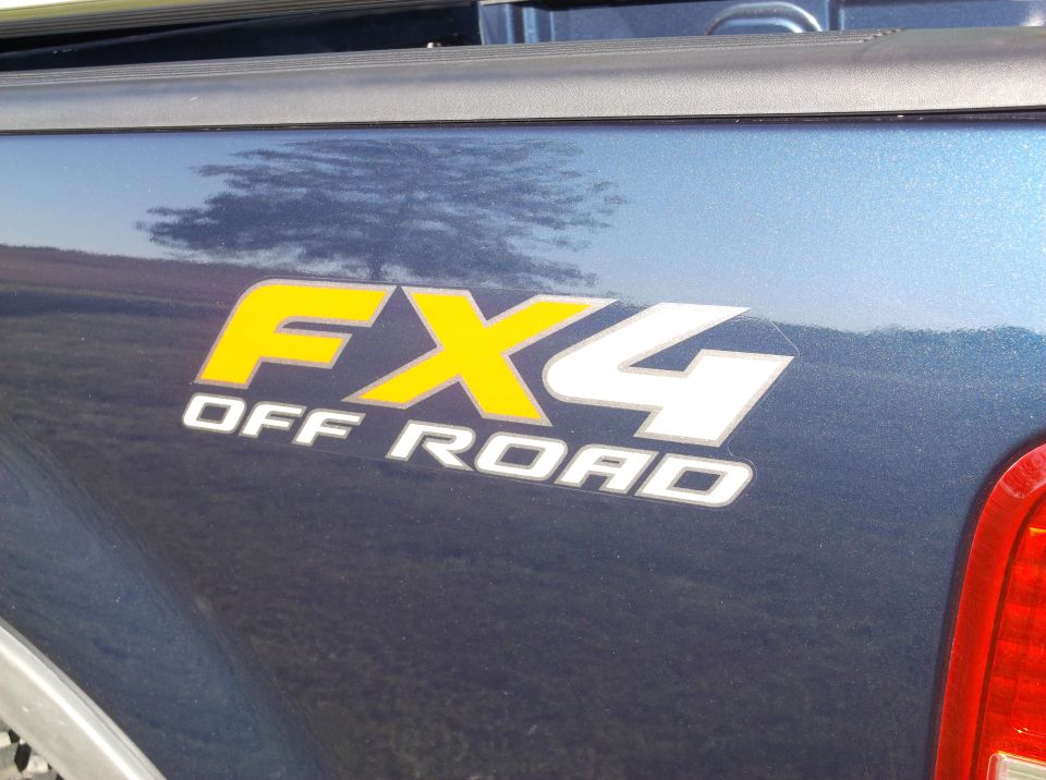 Blue truck bed with yellow and white FX4 OFF ROAD decal