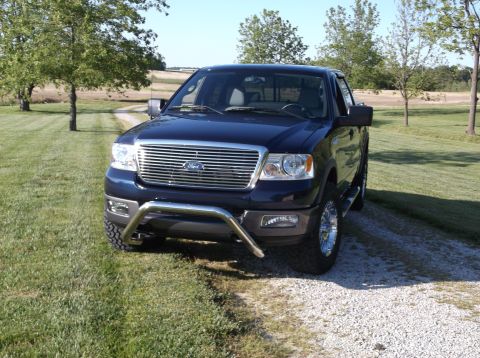 2005 Ford F-150 - Dark blue 2005 Ford F-150 pickup truck shown in a 3/4 front view with a prominent chrome grille and a bull bar.