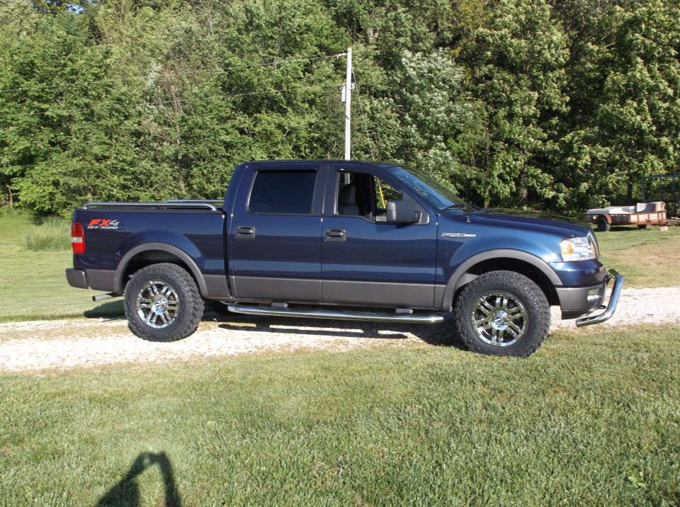 Blue 2005 Ford F-150 FX4 pickup truck, side view