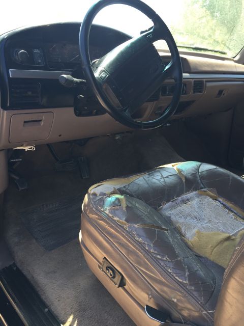 1994 Ford Bronco - The interior of this 1994 Ford Bronco shows significant wear on the leather seats and dashboard.