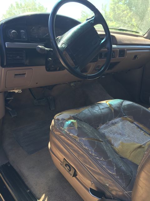 1994 Ford Bronco - The interior of this 1994 Ford Bronco shows significant wear on the driver's seat and dashboard.