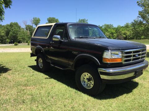 1994 Ford Bronco - This 1994 Ford Bronco is shown in a three-quarter front view, parked outdoors on a grassy area.