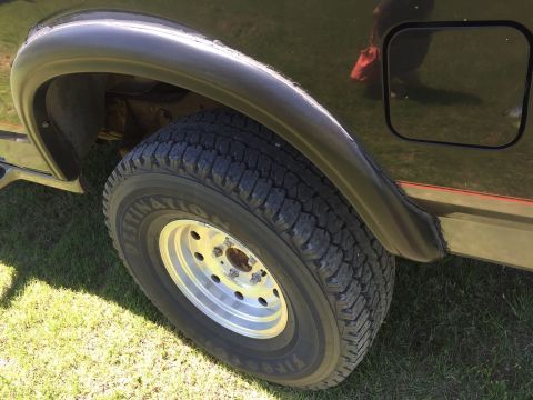 1994 Ford Bronco - Close-up of the rear wheel well and tire on a 1994 Ford Bronco.