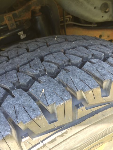1994 Ford Bronco - The image shows a close-up view of a tire's tread pattern.