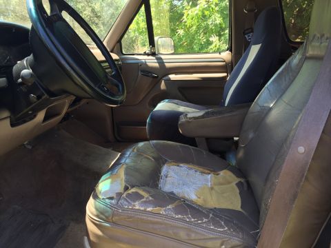 1994 Ford Bronco - Interior view of a 1994 Ford Bronco, highlighting the condition of the seats and dashboard.