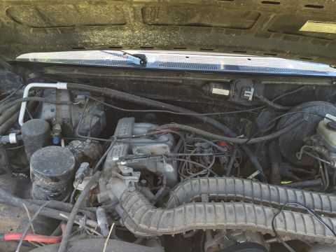 1994 Ford Bronco - Engine bay components including hoses, wiring, and air intake system are visible.