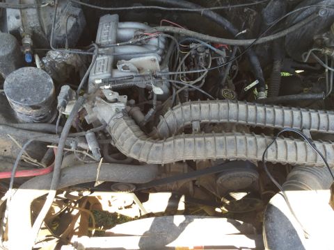1994 Ford Bronco - Close-up view of a vehicle's engine bay, showing various mechanical parts and wiring.
