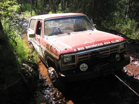 1985 Ford Bronco - This 1985 Ford Bronco, part of the "2 BIG BRONCOS 4X4 CLUB", is stuck deep in the mud during an off-road excursion.