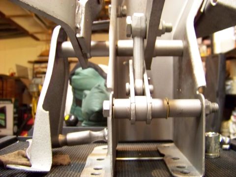 1974 Dodge Challenger - Close-up of a vehicle's pedal assembly, showing mechanical linkages and fasteners.