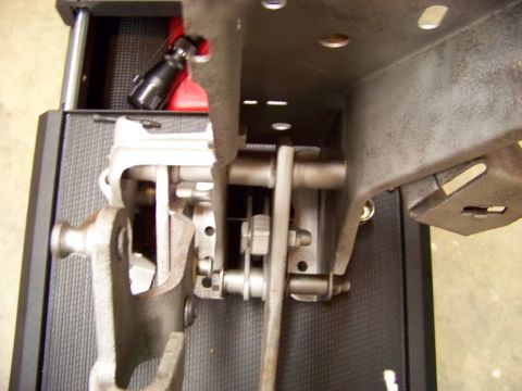 1974 Dodge Challenger - Close-up view of a vehicle's pedal assembly, showing mechanical linkages and pivot points.