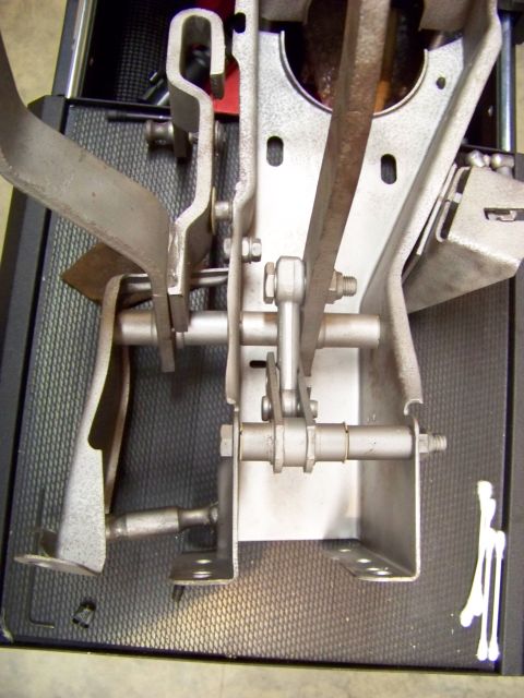 1974 Dodge Challenger - Close-up view of a vehicle's pedal assembly, showing intricate metal levers and linkages.