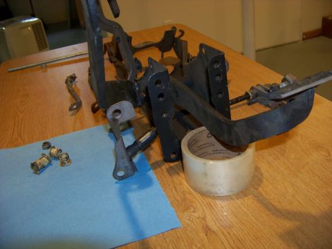 1974 Dodge Challenger - A disassembled vehicle pedal assembly is shown on a table, with various components laid out.