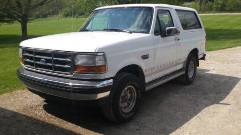 1995 Ford Bronco - White 1995 Ford Bronco parked outdoors on a sunny day.