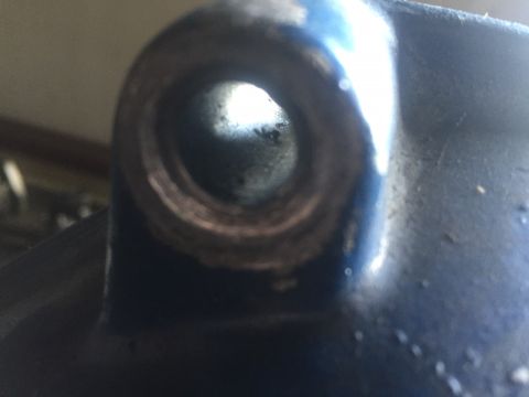 1982 Ford Bronco - A detailed view of a metallic component, showing a circular opening and signs of wear.