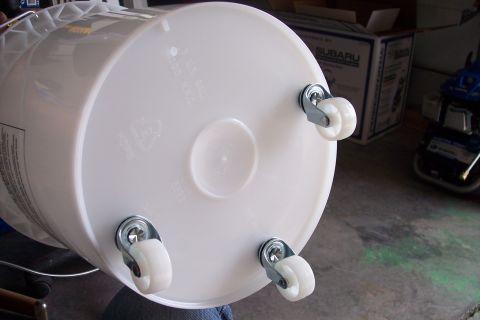 1990 Ford Bronco - A white bucket is modified with four casters for mobility.
