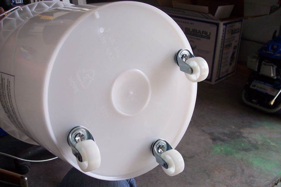 White plastic bucket with four small white casters attached to the bottom