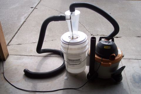 1990 Ford Bronco - DIY cyclone dust separator setup using a shop vac and a 5-gallon bucket.