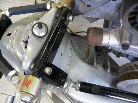 Close-up of a car's rear suspension and part of the engine block