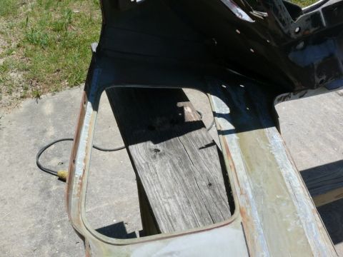 rusted car body panel with cut-out opening