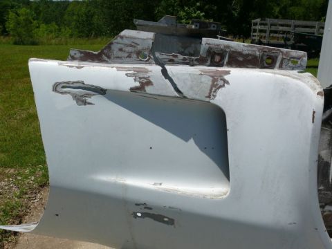 Damaged white car bumper with Supermotors.net logo
