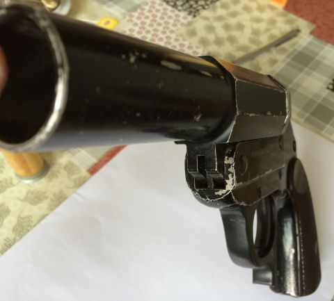 1987 Ford Bronco - Close-up of a black flare gun, showing wear and tear on its metal components.