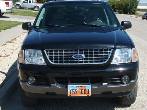 2004 Ford Explorer - This black 2004 Ford Explorer is shown from the front, its chrome grille and a Utah license plate.