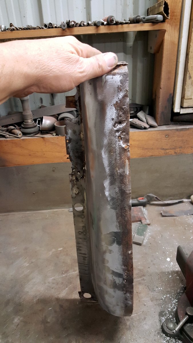 Rusted metal part held by a hand