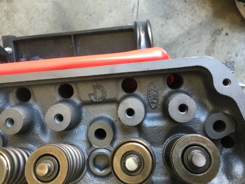 1987 Ford Bronco - Close-up of an engine cylinder head showing the Ford logo and valve train components.
