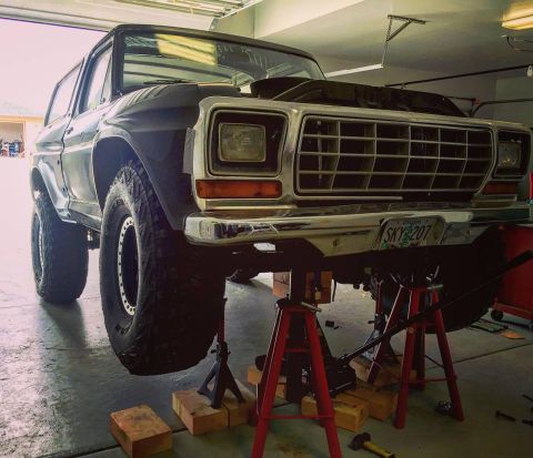 1979 Ford Bronco - This 1979 Ford Bronco is raised on jack stands for maintenance in a garage.