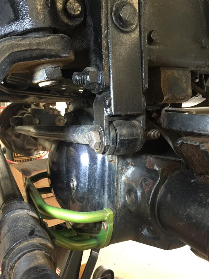 Close-up of vehicle suspension parts, including a differential housing and linkage