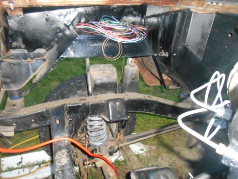 1972 Ford Bronco - The chassis and engine bay wiring of a vehicle are visible in this close-up shot.