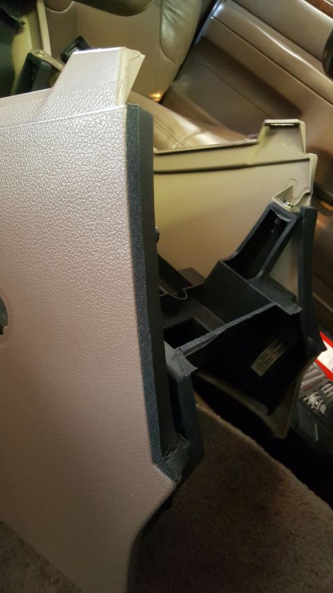 1996 Ford Bronco - Close-up of a removed interior center console trim piece.