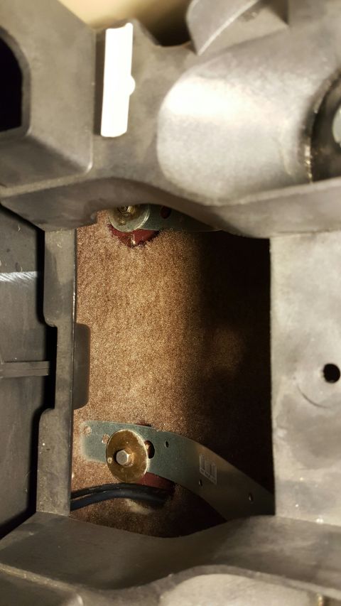 1996 Ford Bronco - This photo shows the interior of a vehicle's center console, revealing carpet and mounting hardware.