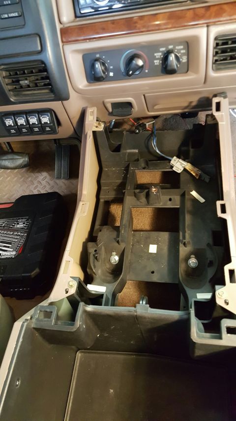 1996 Ford Bronco - Disassembled center console of a 1992 Ford F-Series truck, revealing internal components and wiring harnesses.
