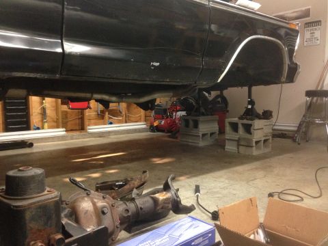 1979 Ford Bronco - 1979 Ford Bronco undergoing suspension work in a garage, front axle removed.