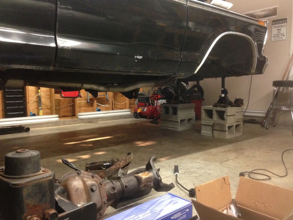 1979 Ford Bronco body on jack stands with front axle removed, parked in garage