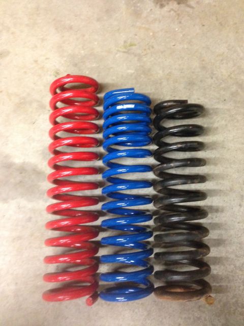 1979 Ford Bronco - Three sets of coil springs are displayed, with red, blue, and black colors visible.