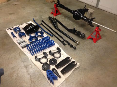 1979 Ford Bronco - Vehicle suspension parts are laid out on a towel, ready for installation or repair.