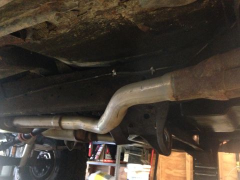 1979 Ford Bronco - Underside view of a vehicle's exhaust system and frame components, with a Supermotors watermark.