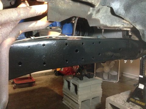 1979 Ford Bronco - The underside of a vehicle is shown, focusing on the frame and exhaust components.