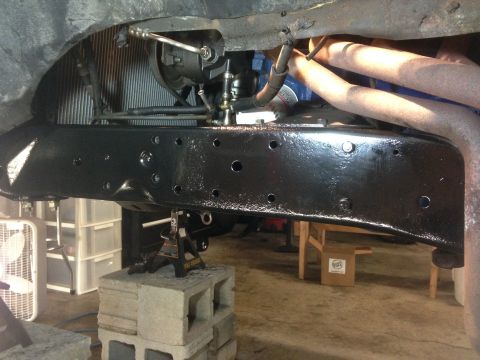 1979 Ford Bronco - Close-up view of vehicle frame and engine components, likely undergoing maintenance or restoration.