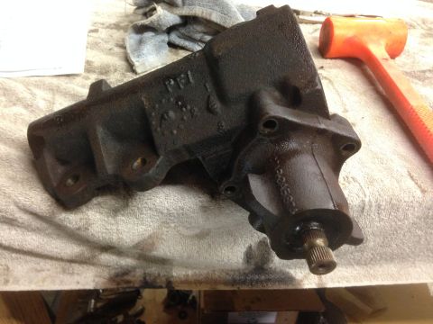 1979 Ford Bronco - A black steering gear box with "PEI" cast into its housing sits on a cloth next to an orange mallet.
