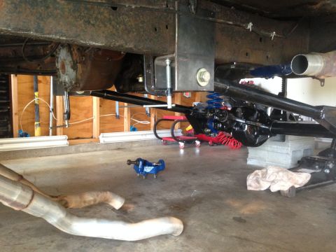 1979 Ford Bronco - Vehicle undercarriage with suspension and exhaust system components visible.