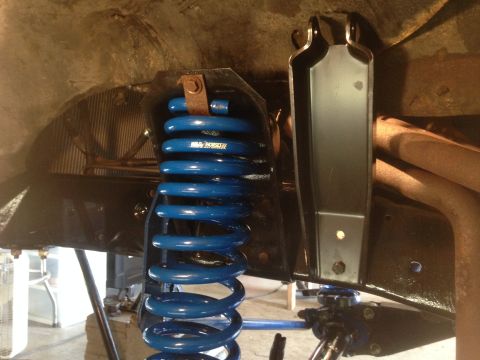 1979 Ford Bronco - Close-up of a blue coil spring and its mounting hardware.